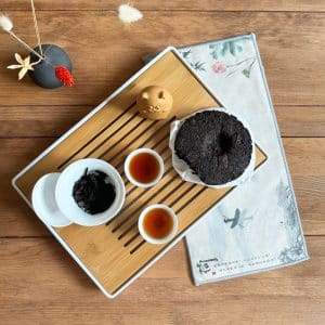 Elephant Beeng Cha tea cake with cat tea pet and gaiwan