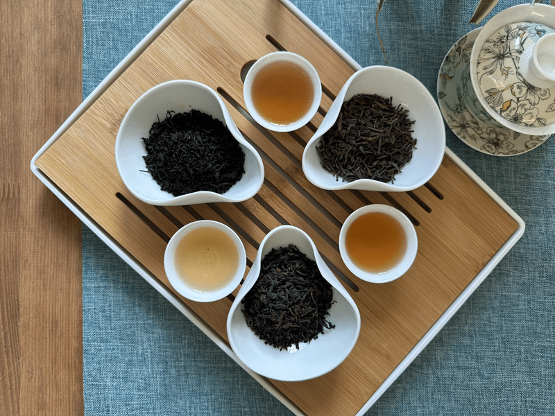a tray with pu'erh tea in display bowls