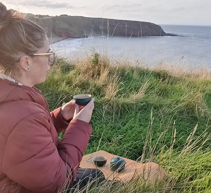 Eric sipping tea outside soaking up earl summer in Scotland