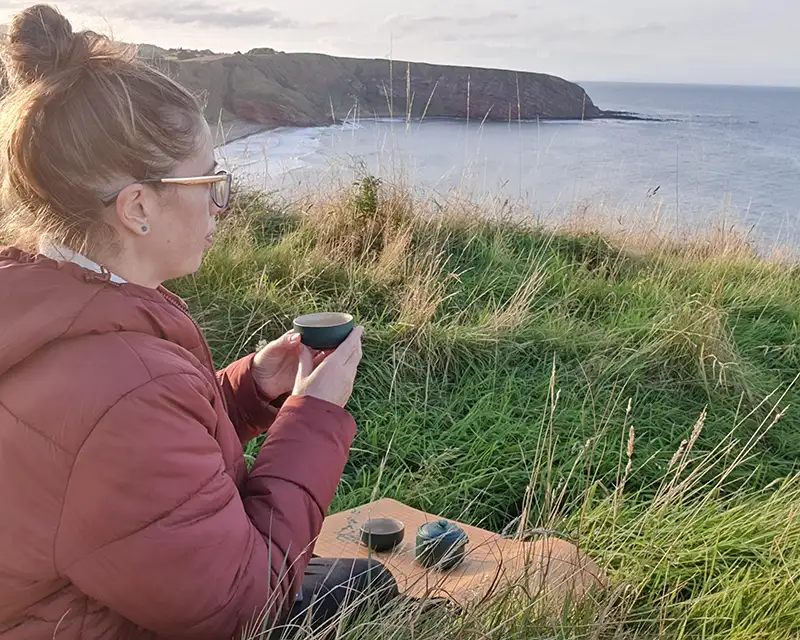 Eric sipping tea outside soaking up earl summer in Scotland