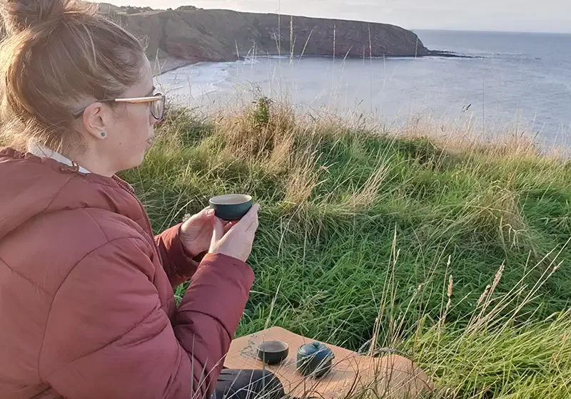 Eric sipping tea outside soaking up earl summer in Scotland