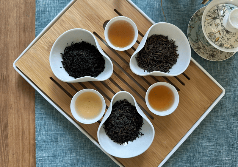 a tray with pu'erh tea in display bowls